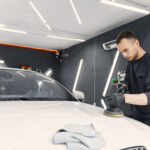 Man polish a car in a garage